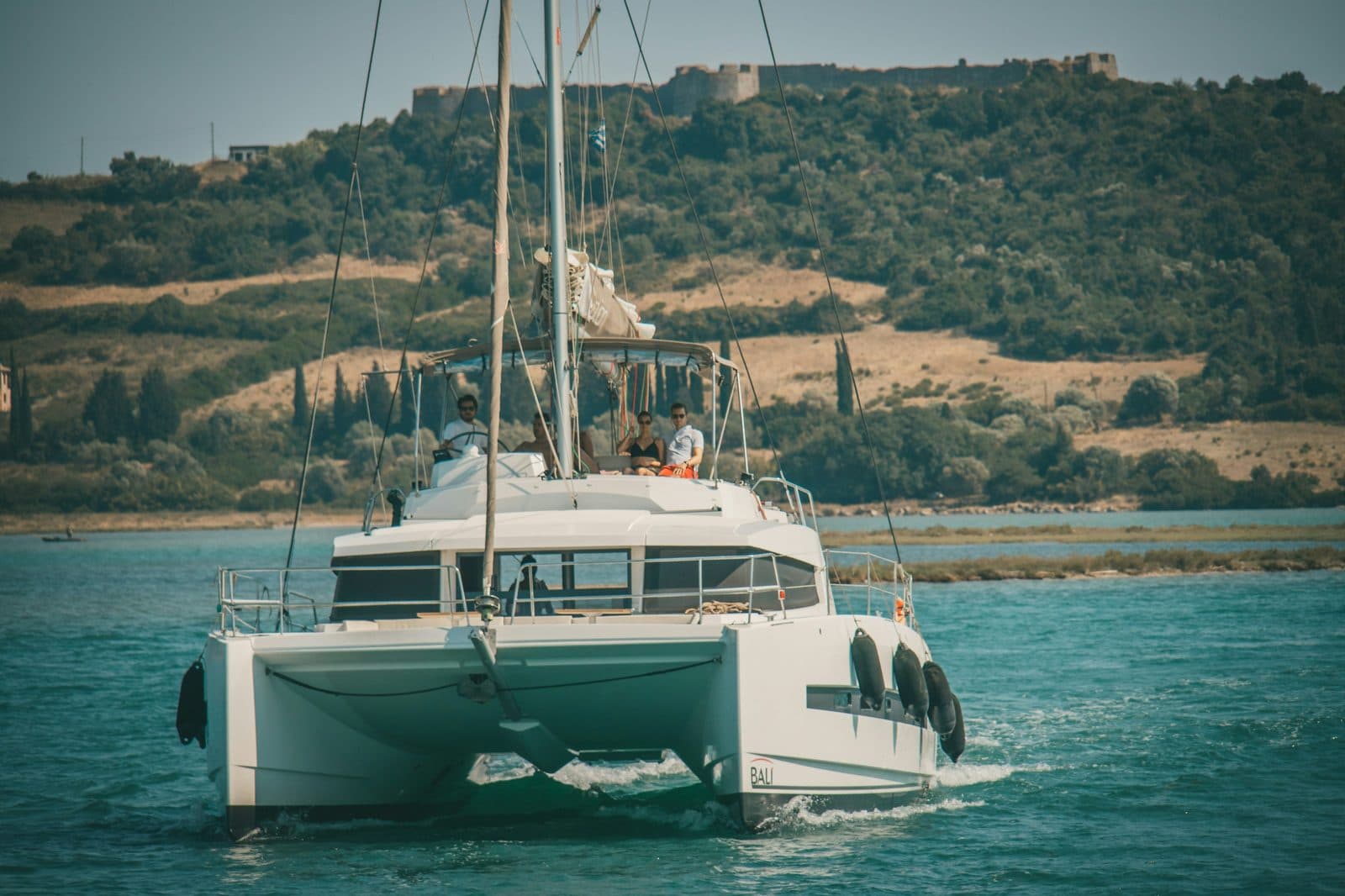 Maxi-catamaran at anchor in clear water